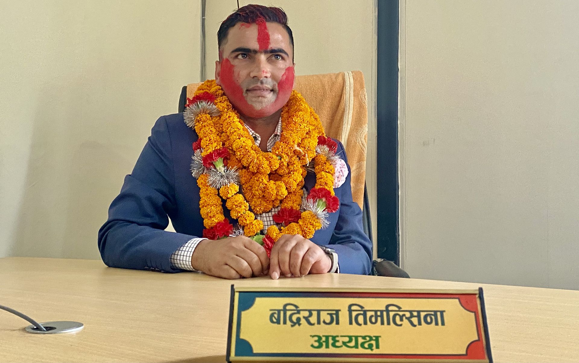Badri Raj Timalsina, garlanded at the president’s desk