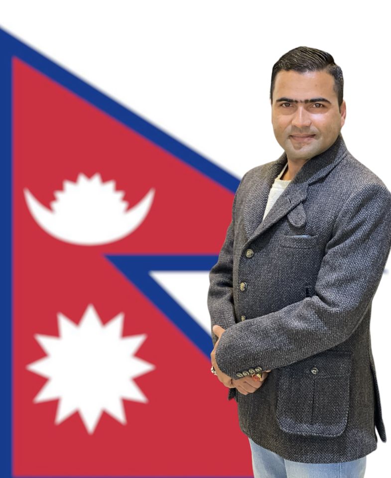 Badri Raj Timalsina in front of the flag of Nepal